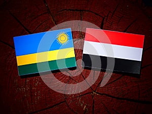 Rwanda flag with Yemeni flag on a tree stump