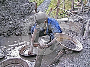 Rwandan Miner Panning For Precious Metals