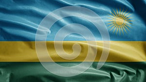 Rwandese flag waving in the wind. Close up of Rwanda banner blowing soft silk photo