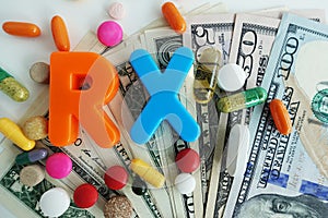 RX acronym from colorful medical pills on cash us dollars