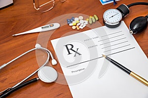 Rx prescription with pills, stethoscope, thermometer