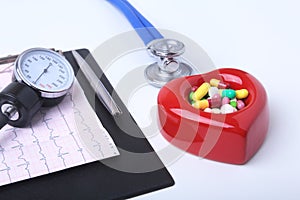 RX prescription, Red heart, asorted pils and a stethoscope on white background