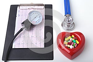 RX prescription, Red heart, asorted pils and a stethoscope on white background