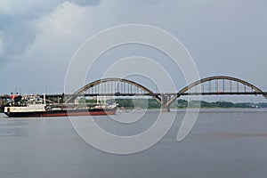 Rybinsk. The river tanker passes through Volga under the bridge