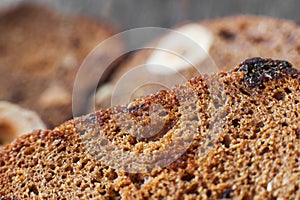 Rye bread background, slices with nuts and raisins