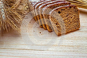 Rye bread. Bakery with crusty loaves and crumbs. Fresh loaf of rustic traditional bread with wheat grain ear or rye spike plant on