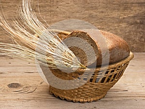 rye bread and ears of corn in basket