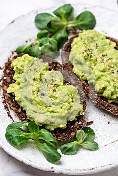 Rye bread with mashed avocado and hemp seeds