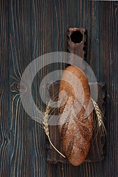 Rye bread over dark wood background