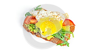 Rye bread sandwich with guacamole, arugula, tomatoes and quail egg isolated on a white background. Bruschetta with