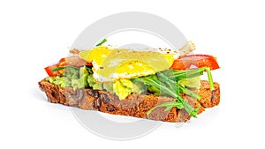 Rye bread sandwich with guacamole, arugula, tomatoes and quail egg isolated on a white background. Bruschetta with