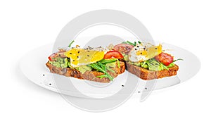 Rye bread sandwich with guacamole, arugula, tomatoes and quail egg isolated on a white background. Bruschetta with