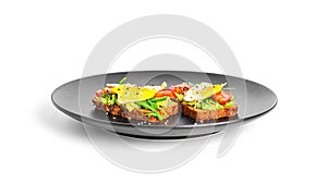 Rye bread sandwich with guacamole, arugula, tomatoes and quail egg isolated on a white background. Bruschetta with