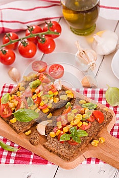 Rye bread withsweet  corn, basil and tomato.