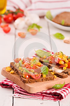 Rye bread withsweet  corn, basil and tomato.