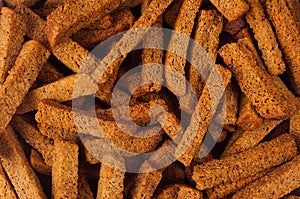 Rye croutons sticks as background. Beer snacks texture.