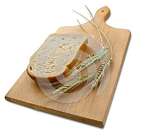 Rye ears (spikes) and loafs of bread on wooden board photo