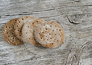 Rye flatbread on rustic light wooden surface.