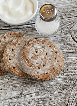 Rye flatbread on rustic light wooden surface.