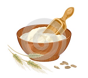 Rye flour in wooden bowl, spoon, grain and spikelet