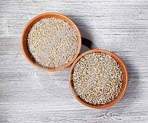 Rye groats and grains in round ceramic bowls
