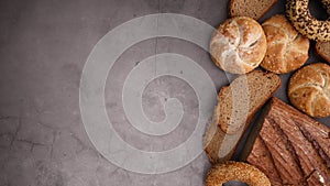 Rye organic bread, bugles with sesame and flax and buns appear on right side - Stop motion