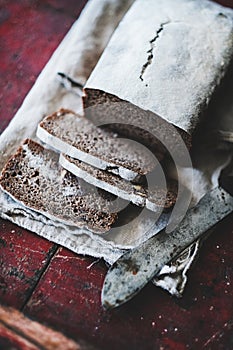 Rye Swedish bread loaf cut in slices with vintage knife