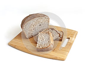 Rye and wheat bread. A piece of bread. A loaf of bread on a cutting board. Isolated image. Food