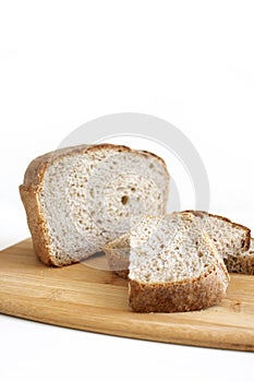 Rye and wheat bread. A piece of bread. A loaf of bread on a cutting board. Isolated image. Food