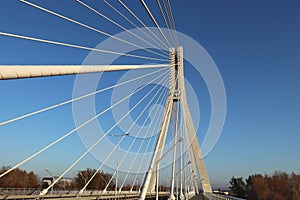 Rzeszow, Poland - 9 9 2018: Suspended road bridge across the Wislok River. Metal construction technological structure. Modern arch