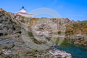 S`Arenella Lighthouse at the Coastline of Mediterranean Sea Catalonia, Spain photo