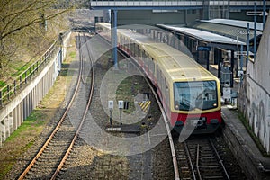 S bahn or suburban trains in Berlin, Germany. Modern red and yellow train for commuting purposes, on station of Messe Sud on a photo
