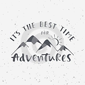 It`s the best time for adventures. Handwritten lettering phrase with mountains silhouette.