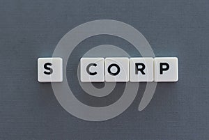 S Corp word made of square letter word on grey background photo