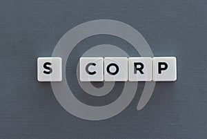 S Corp word made of square letter word on grey background