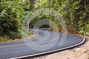 S curved asphalt road view in the forest