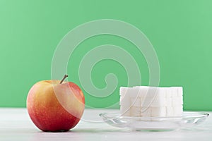 It s hard to choose healthy food concept, with woman hand holding an green apple and a calorie bomb donut