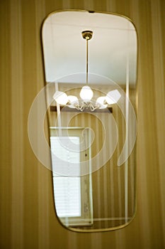 60`s or 70`s interior: Lamp in a mirror photo