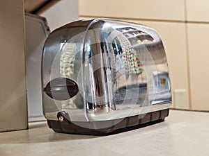 1950`s kitchen reflected in a toaster