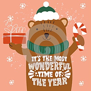 It`s the most wonderful time of year. The bear with a gift in a hand. Merry Christmas and Happy new year 2021.