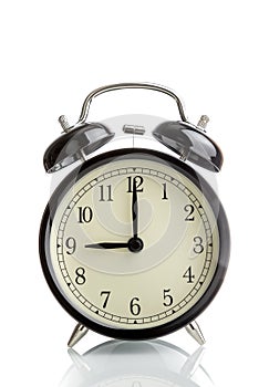 It`s nine o`clock already, time to wake up for breakfast, vintage old black metallic alarm clock