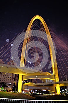 The beautiful Arco da InovaÃ§Ã£o taiada bridge at night with its lighting photo