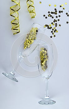 It`s party time! Two champagne glasses with sparkling decorations.