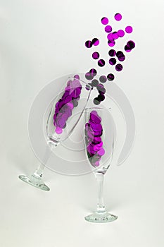 It`s party time! Two champagne glasses with sparkling decorations.