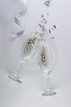 It`s party time! Two champagne glasses with sparkling decorations.