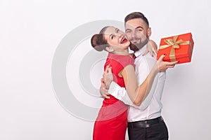 It`s present for you! Couple hugging, woman holding gift box