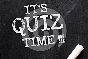 IT`S QUIZ TIME !!! words written on a black chalk board