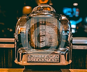 A 1960s retro mini jukebox radio on a tabletop,