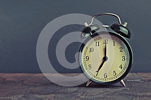 It`s seven o`clock already, time to wake up for breakfast, vintage old black metallic alarm clock