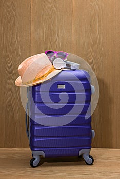 It`s summer time. Travel bag and straw hat.